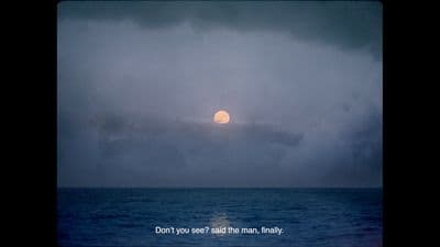 the sun is setting over the ocean on a cloudy day