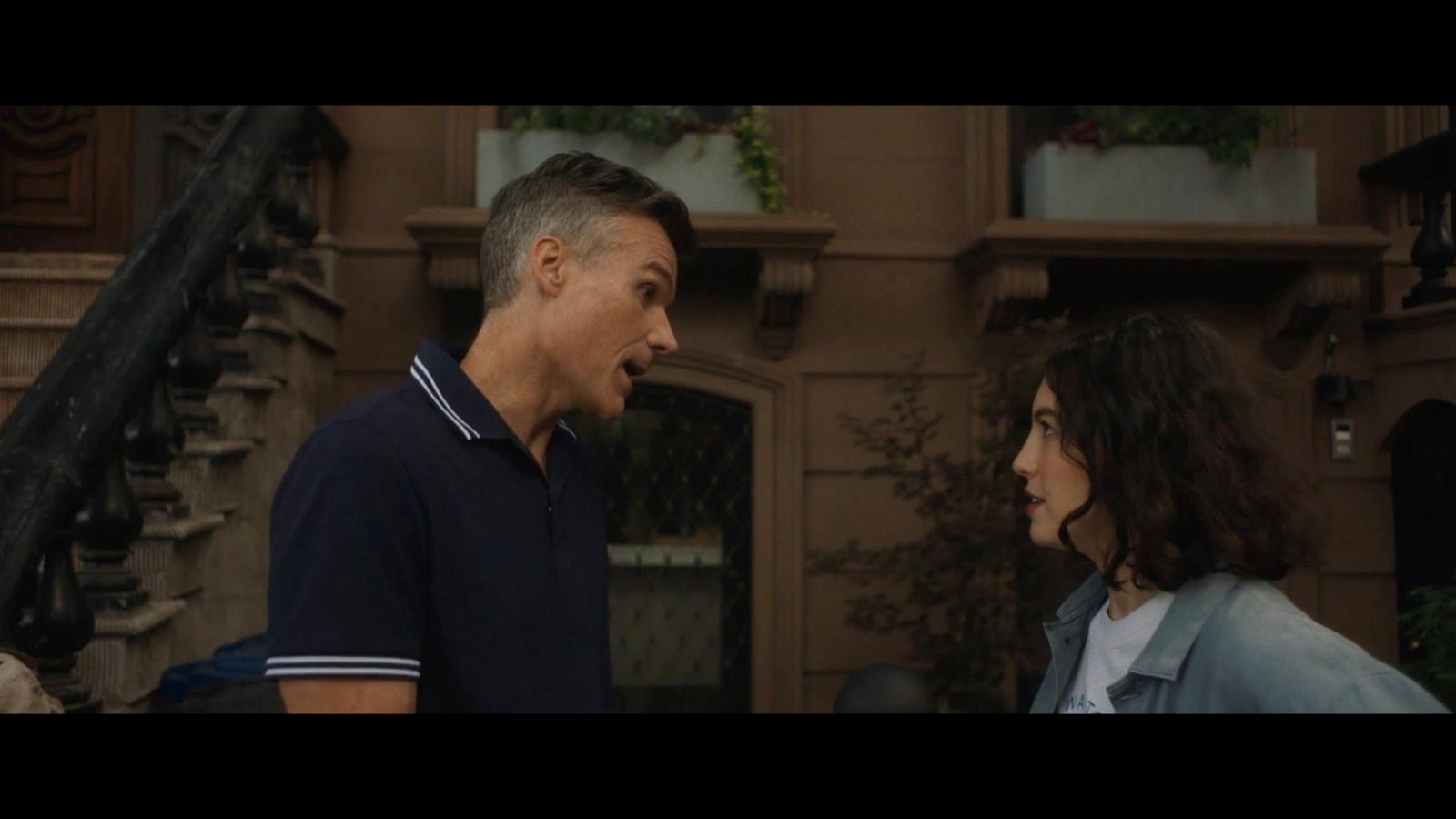 a man and a woman walking together in front of a building