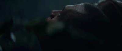 a person with their eyes closed in the dark