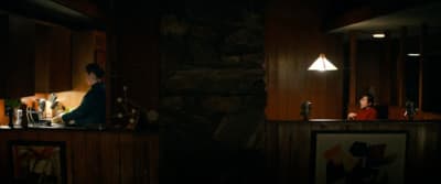 a woman sitting at a bar in a dimly lit room