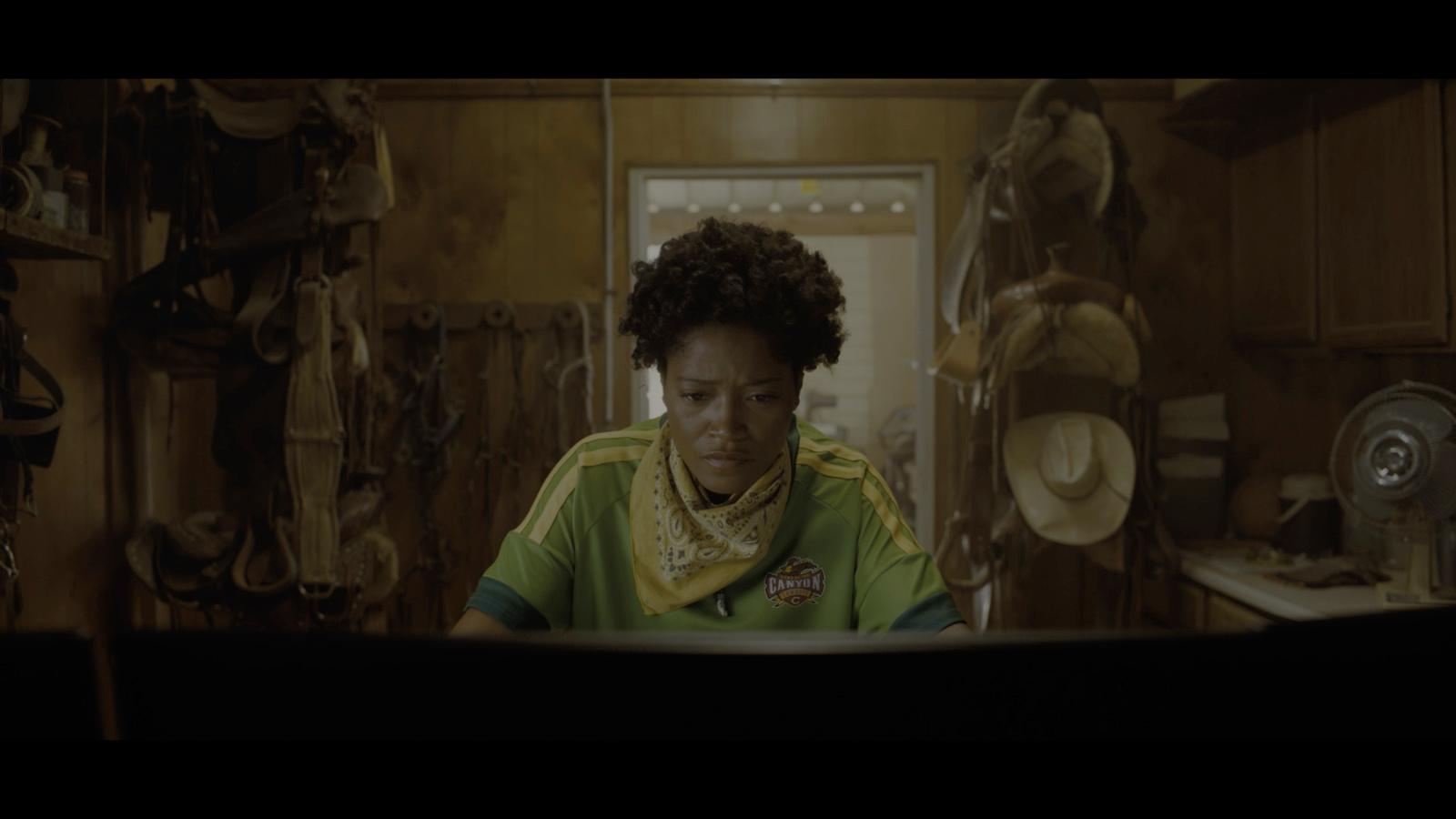 a woman sitting at a table in a kitchen