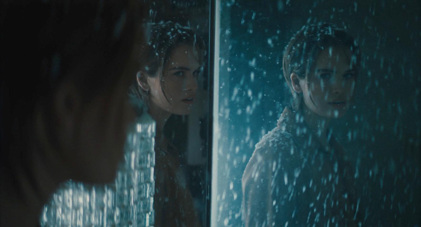 a woman looking at herself in a mirror