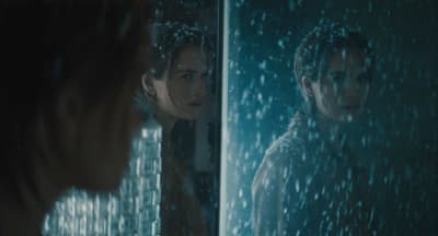 a woman looking at herself in a mirror