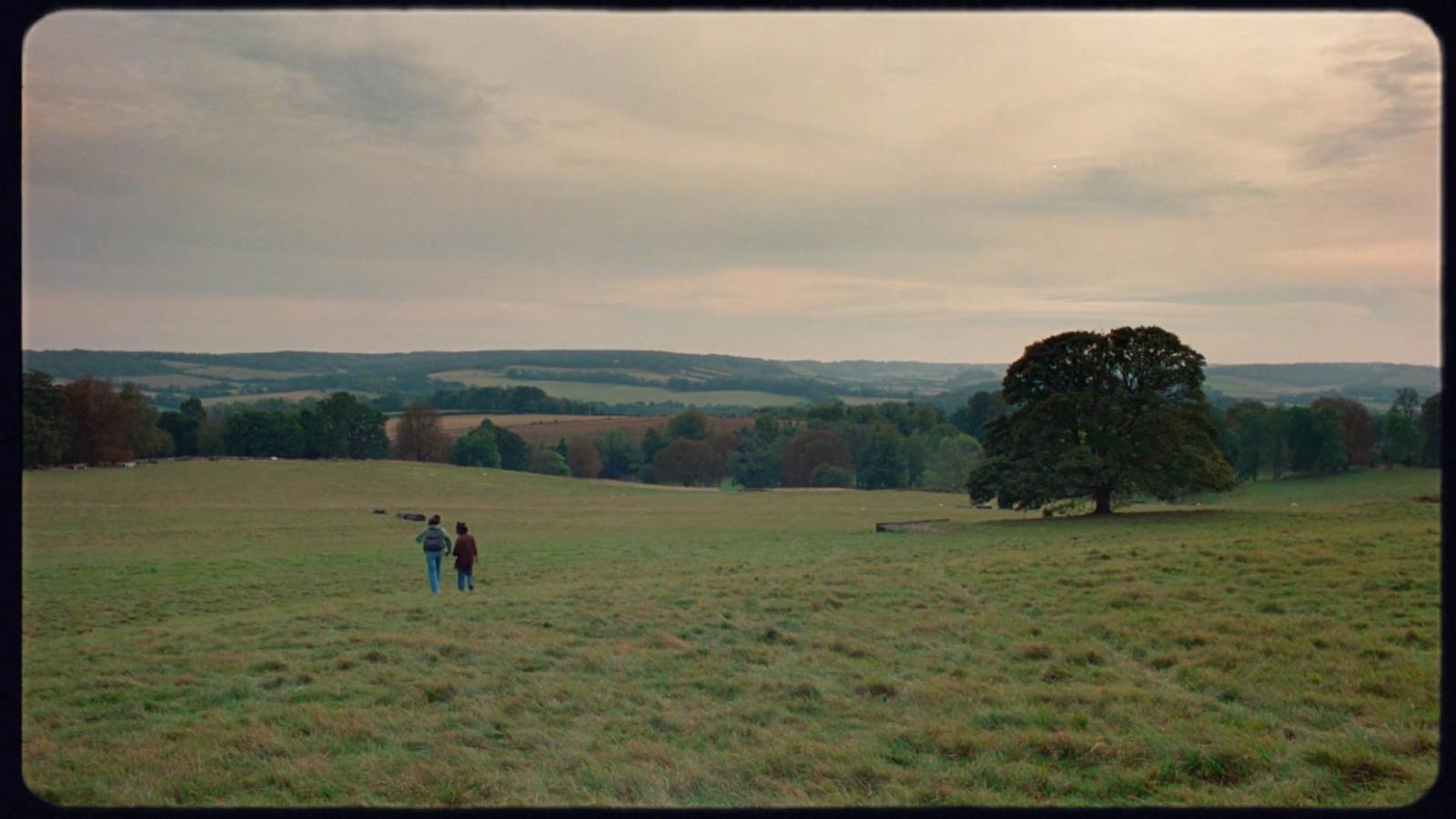 a couple of people standing in a field