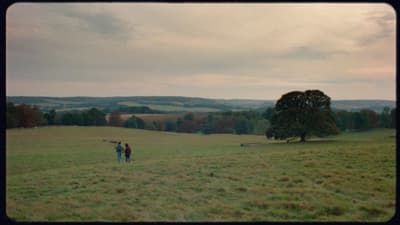 a couple of people standing in a field