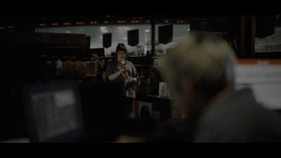 a woman standing in front of a computer screen