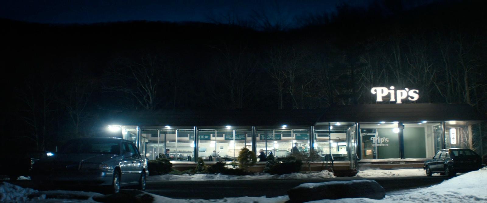 a car parked in front of a store at night