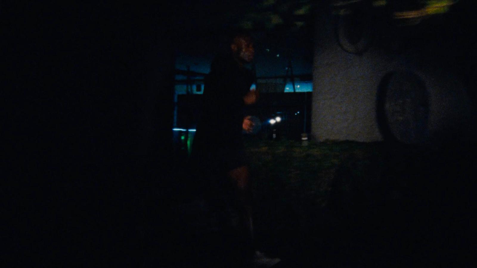 a person standing in the dark with a flashlight