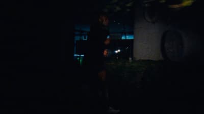 a person standing in the dark with a flashlight