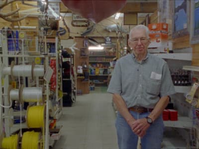 a man standing in a store with a large balloon in the background