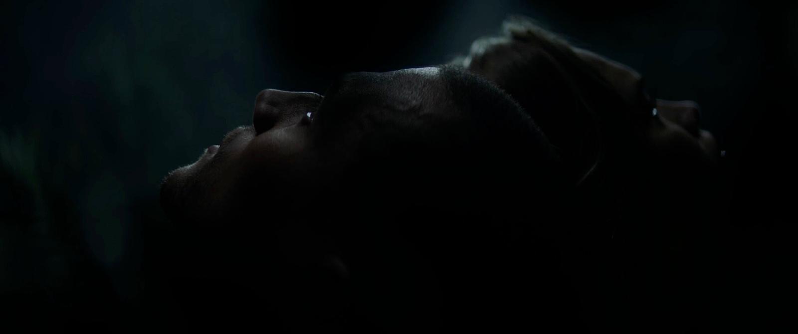 a close up of a person's face in the dark
