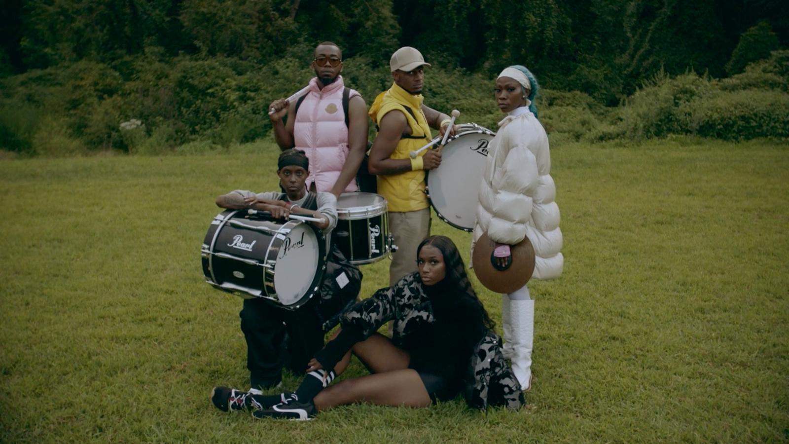 a group of people that are standing in the grass