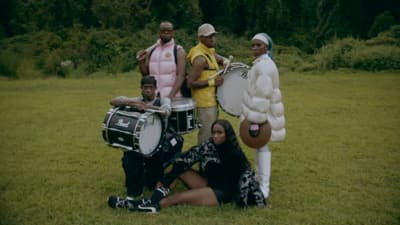 a group of people that are standing in the grass