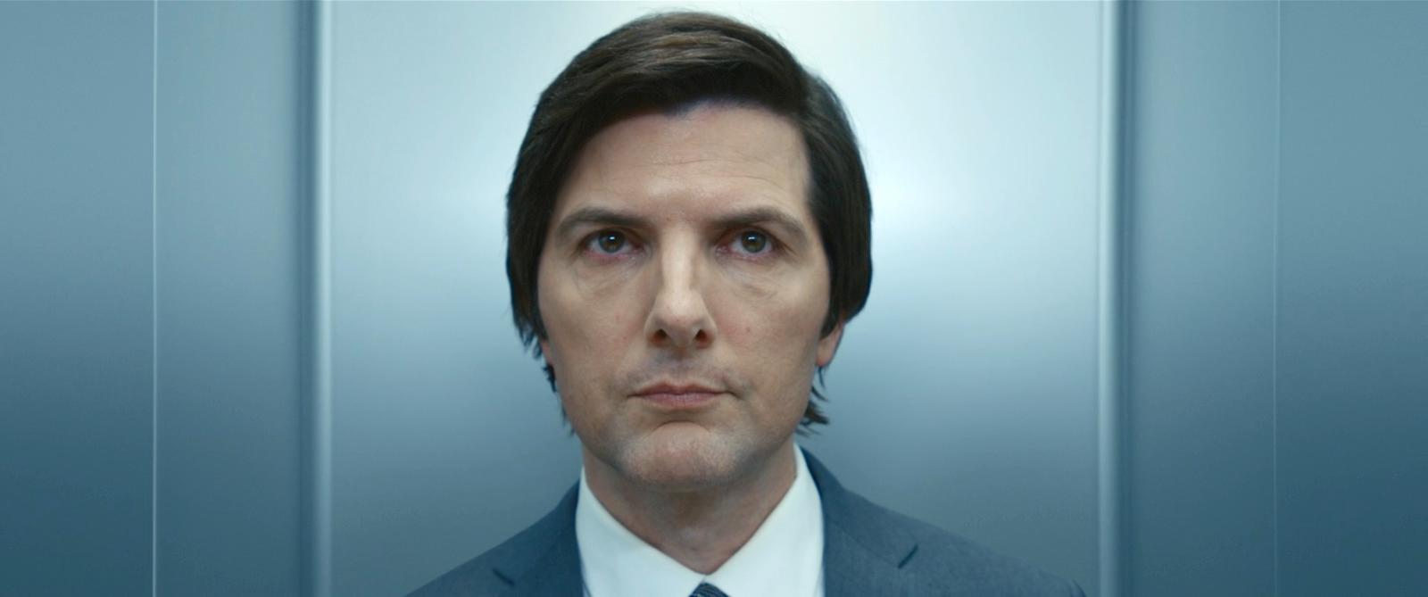 a man in a suit and tie looking at the camera
