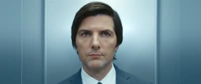 a man in a suit and tie looking at the camera