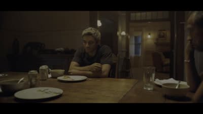 a man sitting at a table with a plate of food