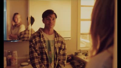 a man standing in front of a mirror in a bathroom