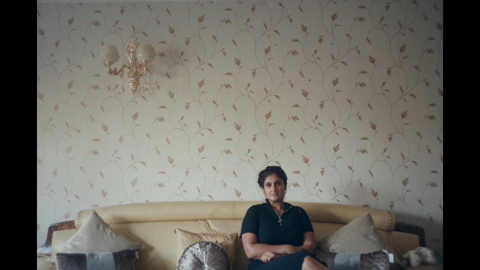 a woman sitting on a couch in a living room