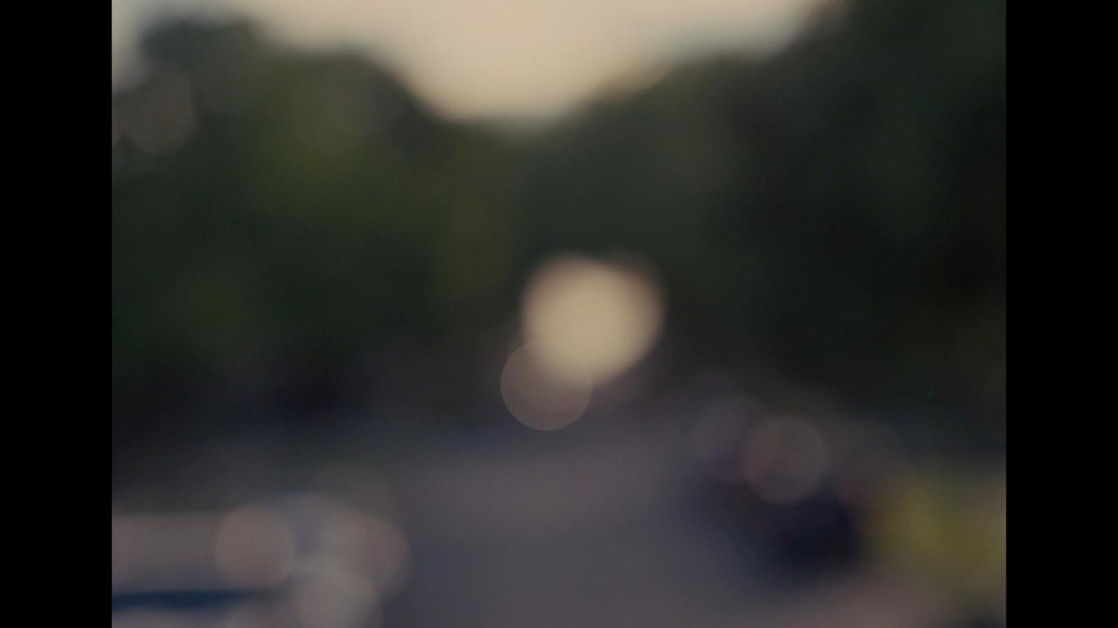 a blurry picture of a street with cars on it