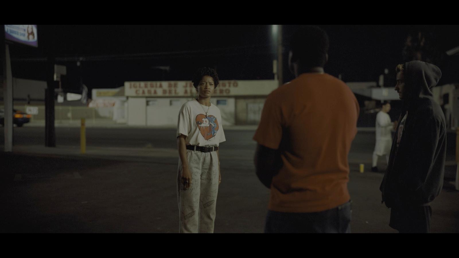 a group of people standing around a parking lot