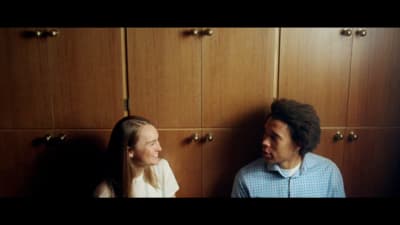 a man standing next to a woman in a kitchen