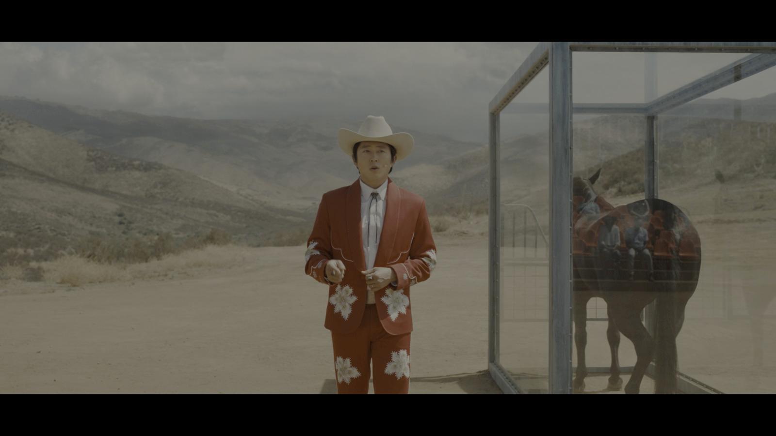 a man in a red suit and cowboy hat