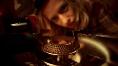 a close up of a person operating a stove