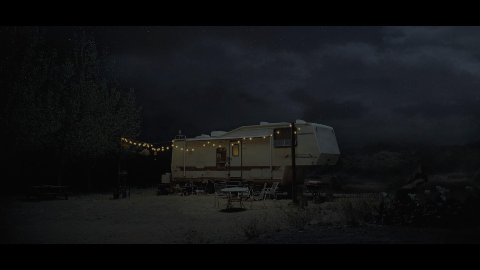 a trailer parked in a field at night