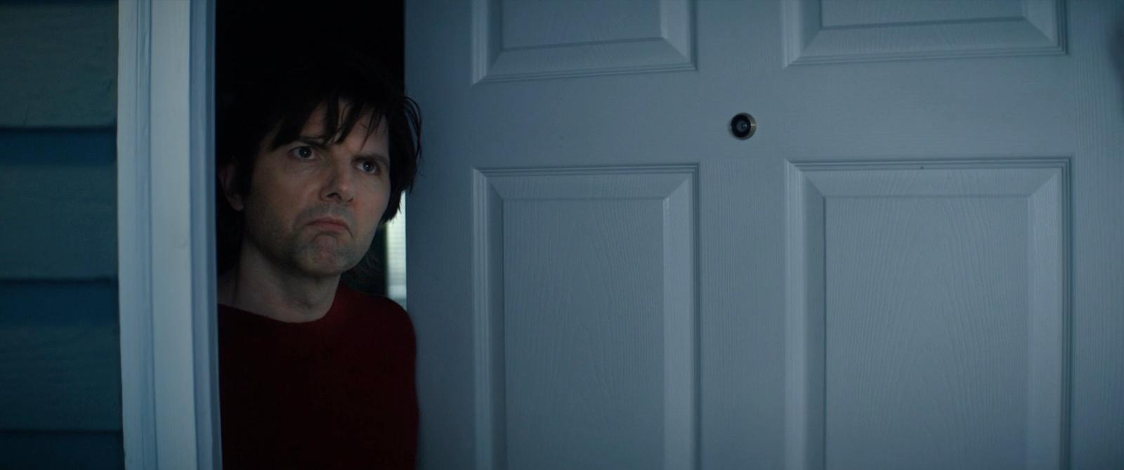 a man standing in front of a white door