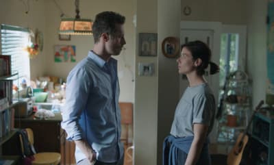a man standing next to a woman in a kitchen