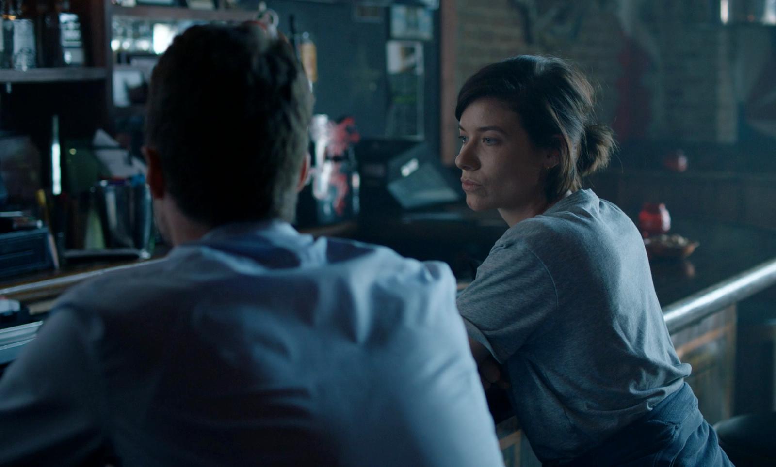 a man and a woman sitting at a bar