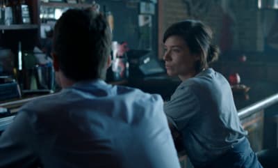a man and a woman sitting at a bar
