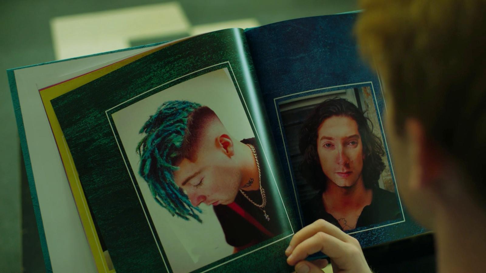 a person holding a book open to a picture of a woman with dreadlocks