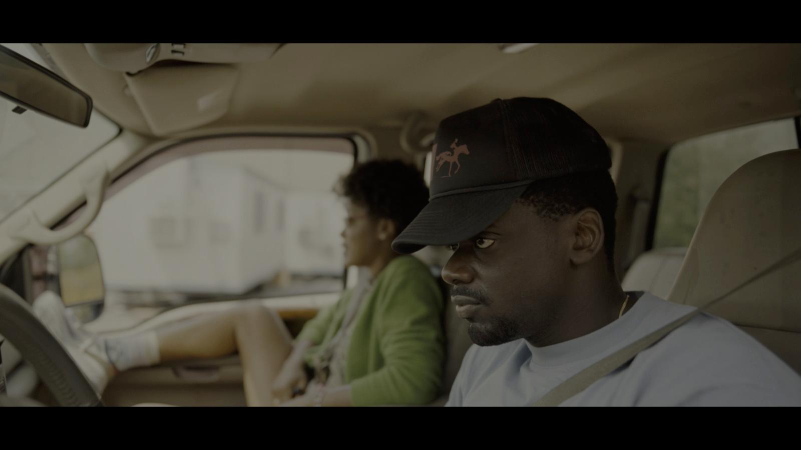 a man and a woman sitting in a car