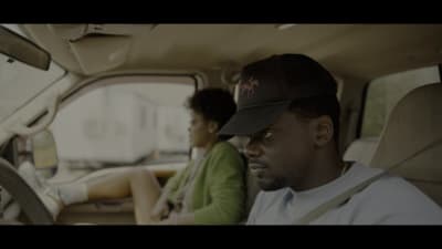 a man and a woman sitting in a car