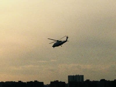 a helicopter flying in the sky over a city