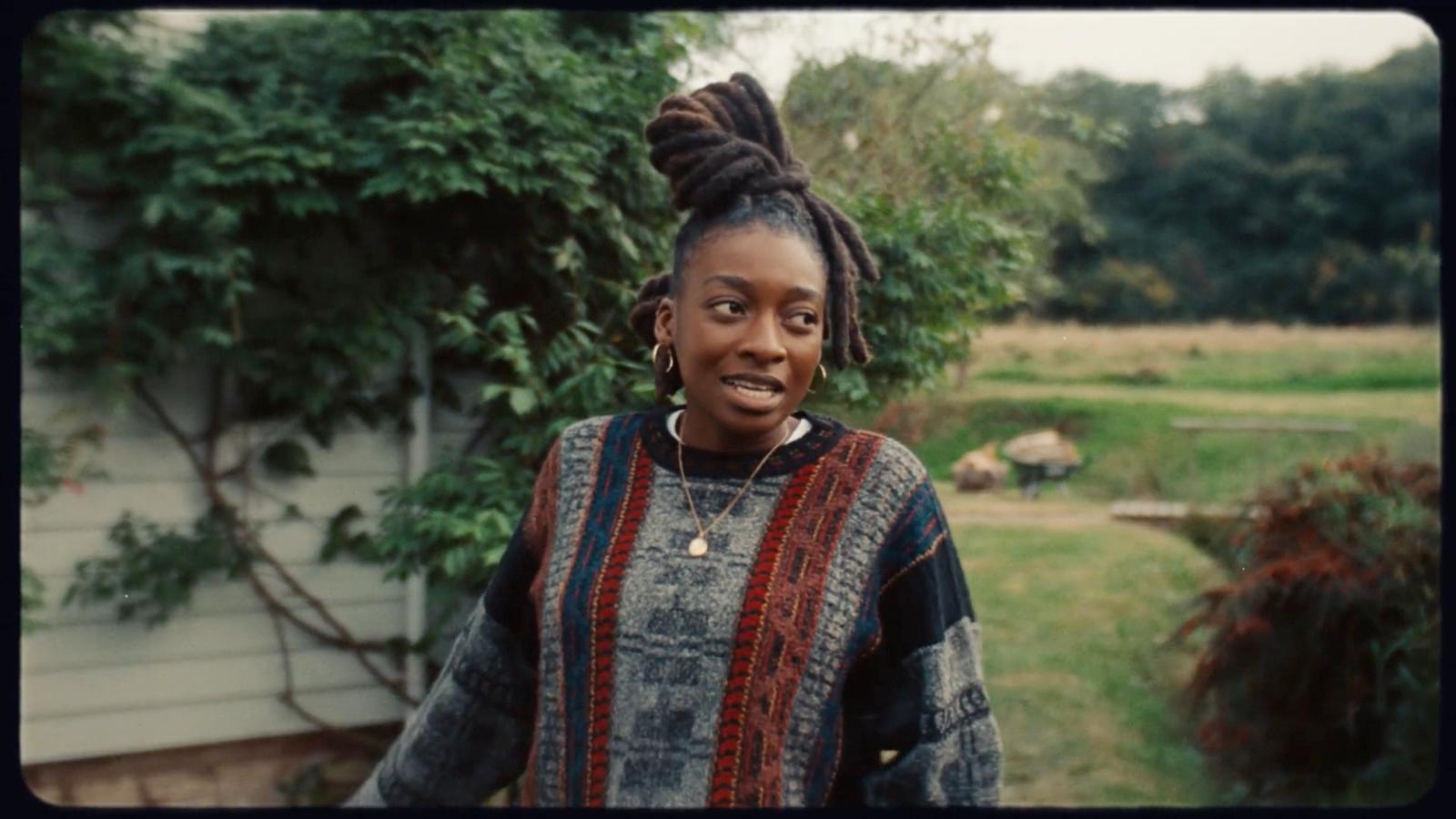 a woman standing in front of a house