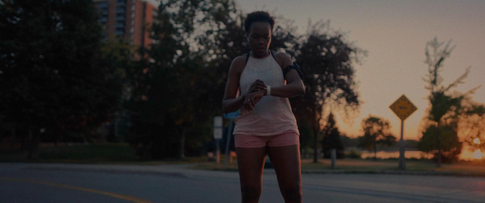 a woman riding a skateboard down a street