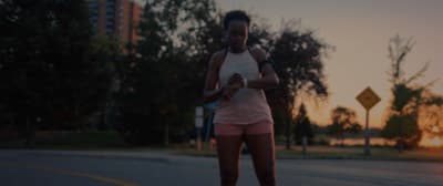 a woman riding a skateboard down a street