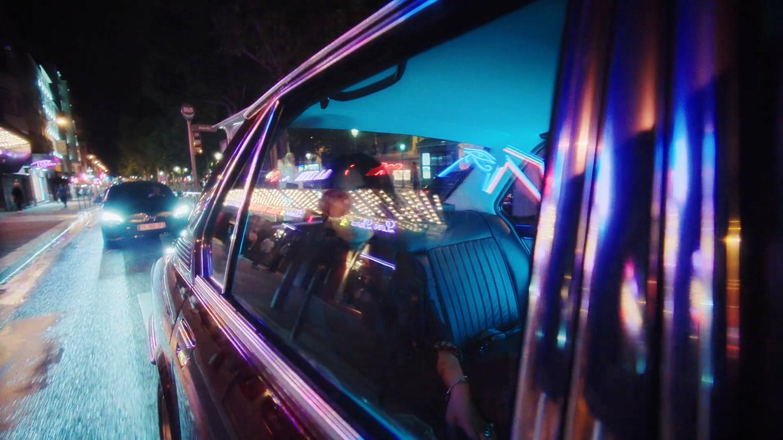 a car driving down a city street at night