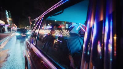 a car driving down a city street at night