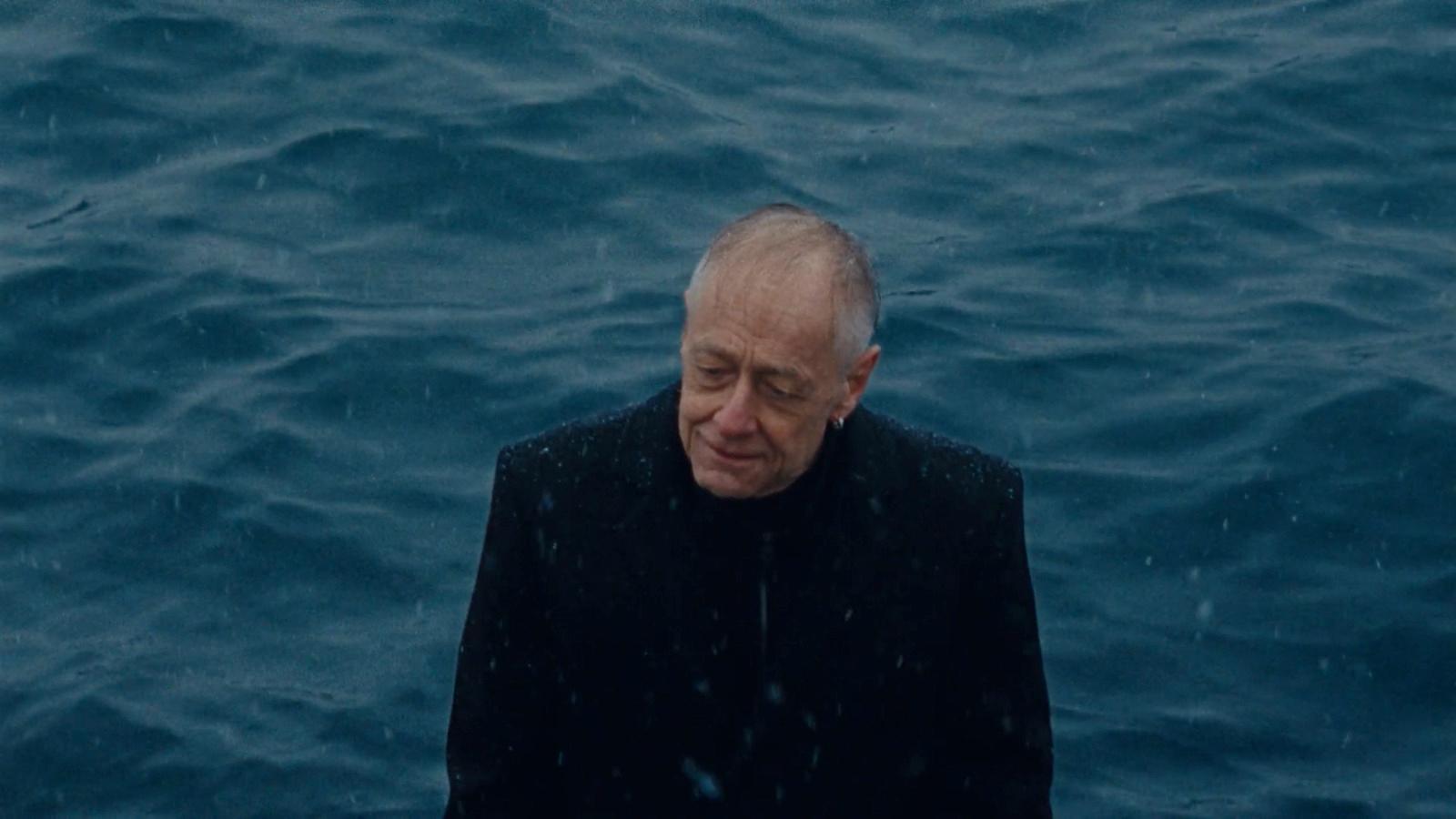 a man standing in the middle of a body of water