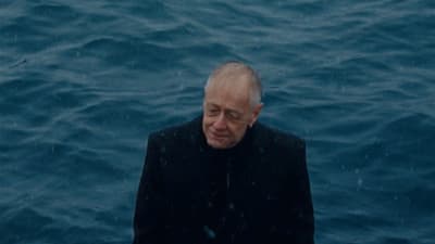 a man standing in the middle of a body of water