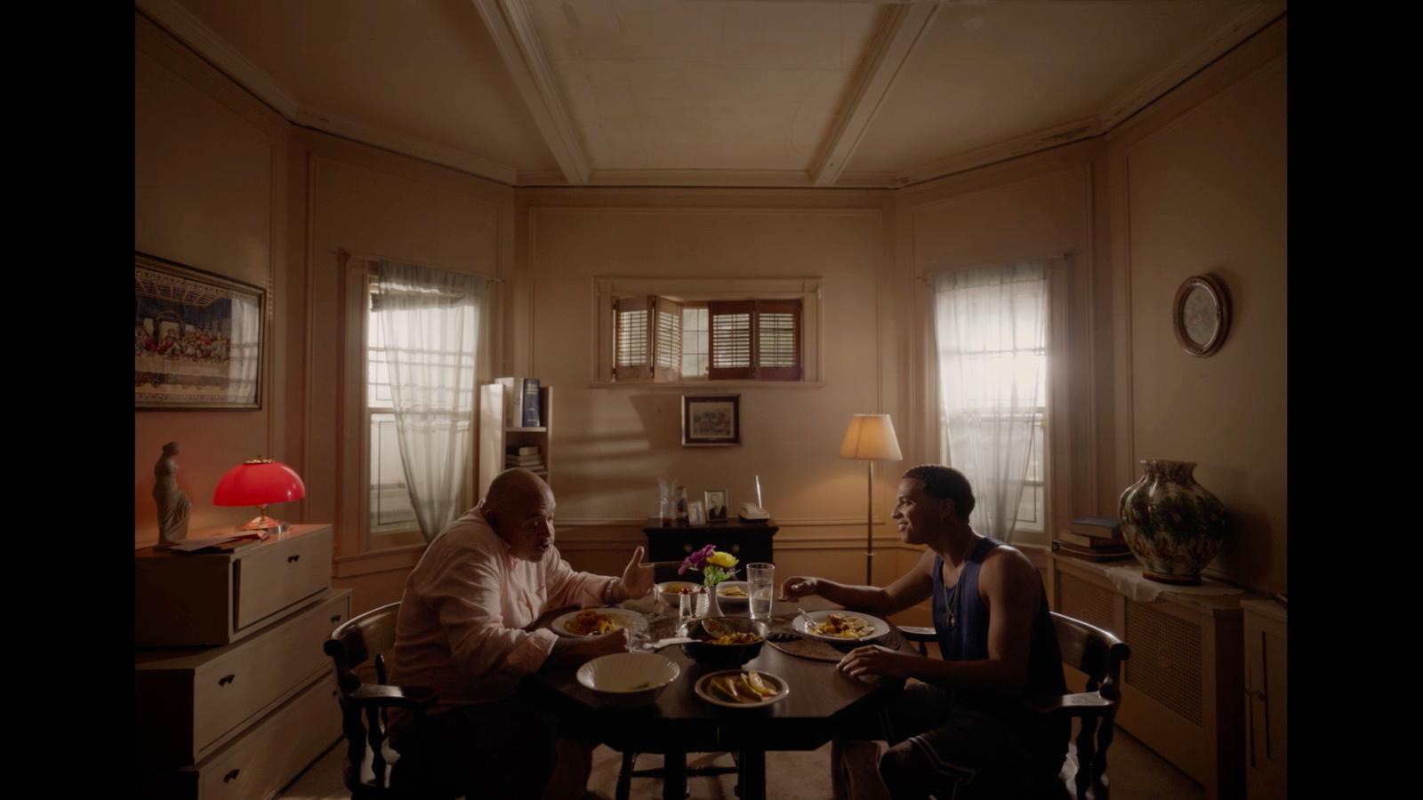 a couple of people sitting at a table eating food