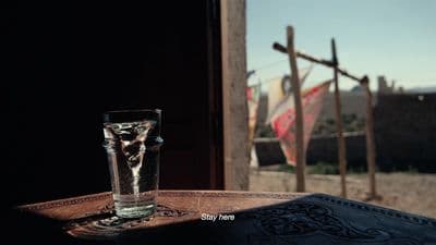 a glass of water sitting on top of a table