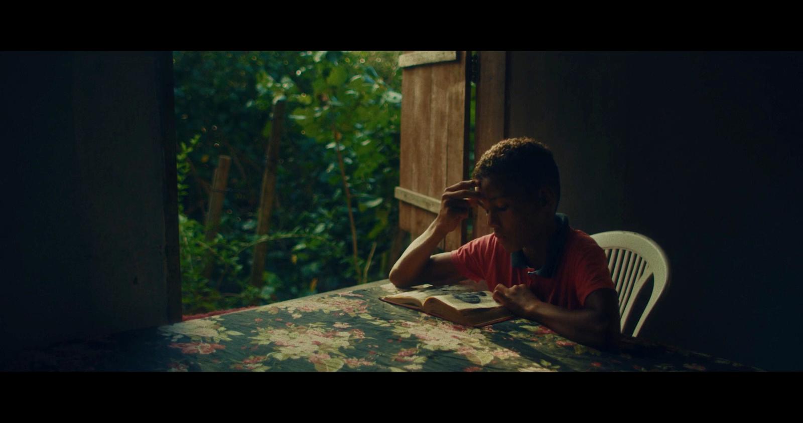 a person sitting at a table with a book