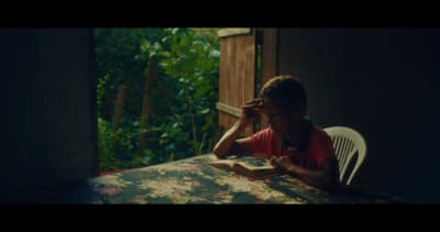 a person sitting at a table with a book