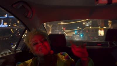 a woman sitting in the back seat of a car