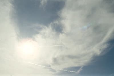 the sun is shining through the clouds in the sky