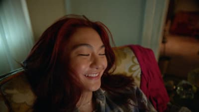 a woman sitting in a chair with her eyes closed